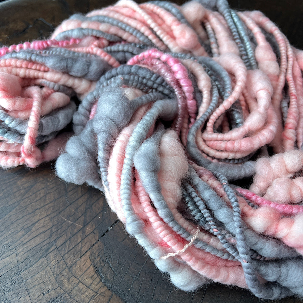 Pink and grey spiral hand spun yarn