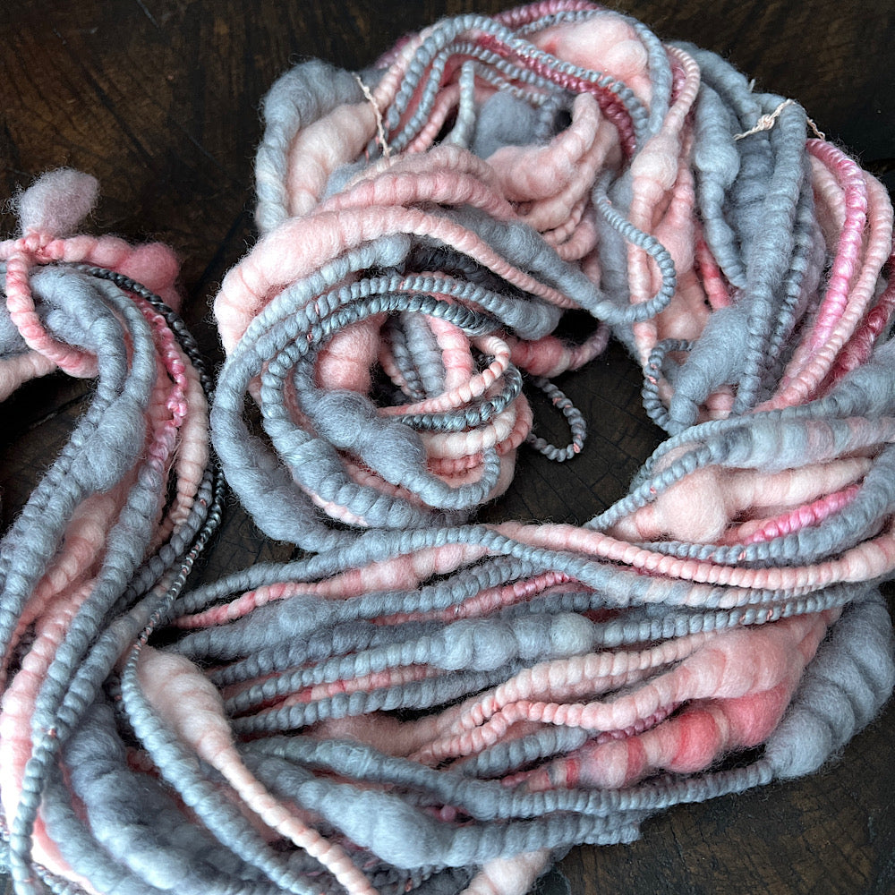 Pink and grey spiral hand spun yarn