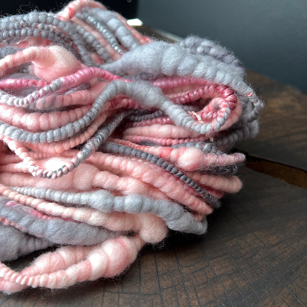 Pink and grey spiral hand spun yarn