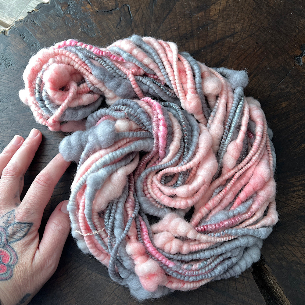 Pink and grey spiral hand spun yarn